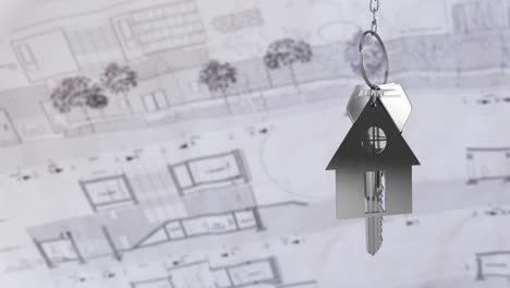 house keys and key fob hanging over architectural drawing 4k