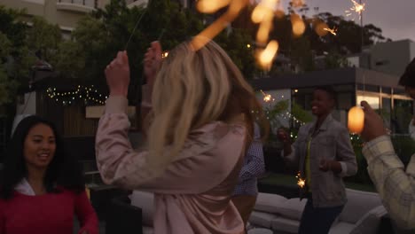 group of friends dancing together on a rooftop