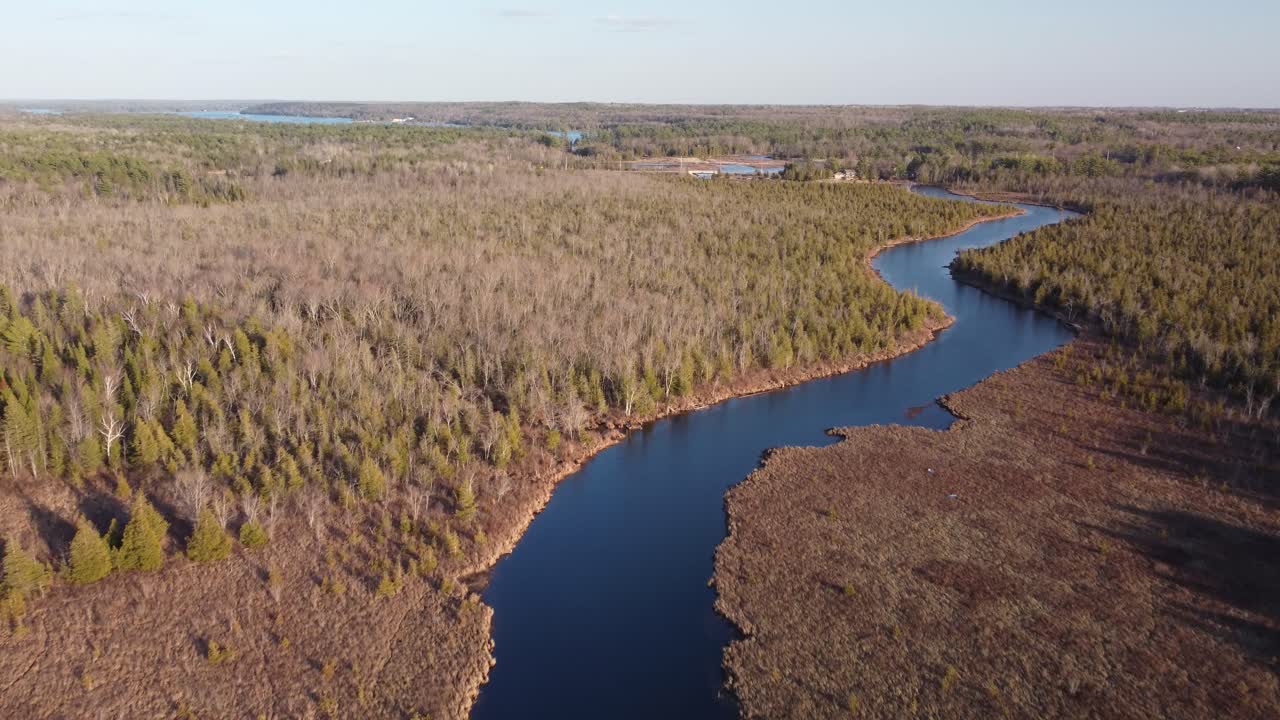 Innkjøring med drone over elv omgitt av skog og trær ved den gylne timen Highlands05.