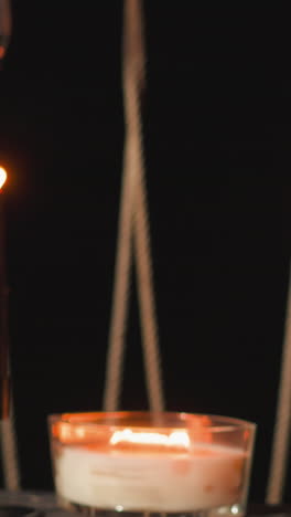 couple clinks glasses of wine closeup. newlyweds indulge in romantic candlelit dinner on terrace of glamorous camping site celebrating weeding