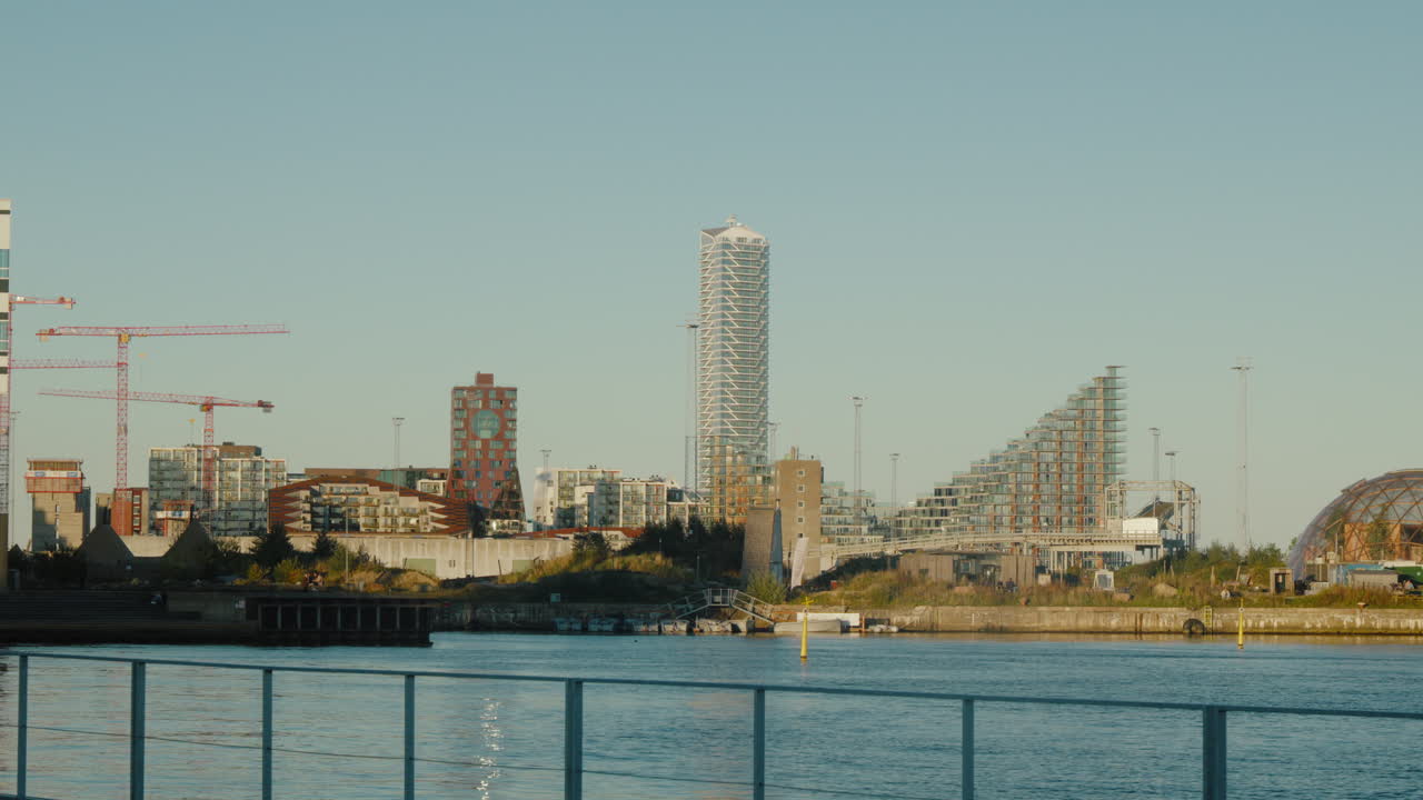Modern cityscape view of Aarhus waterfront with unique architecture. Perfect for travel documentaries highlighting Denmark’s urban design.