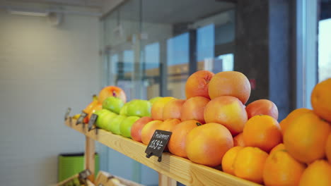 customer selecting grapefruit in a grocery store