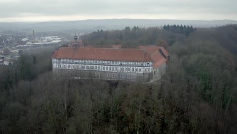 drone aerial view of the traditional german village herzberg am harz in the famous national park in central germany on a cloudy day in winter.