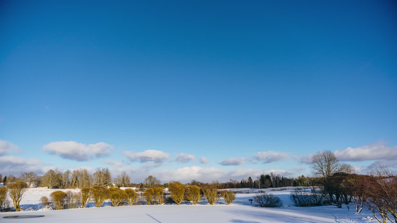 Winter sunset timelapse over snowy countryside landscape