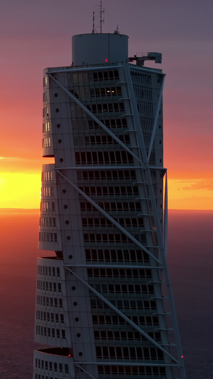 Aerial drone view of Turning Torso residential skyscraper in Malmo, Sweden at sunset. Vertical