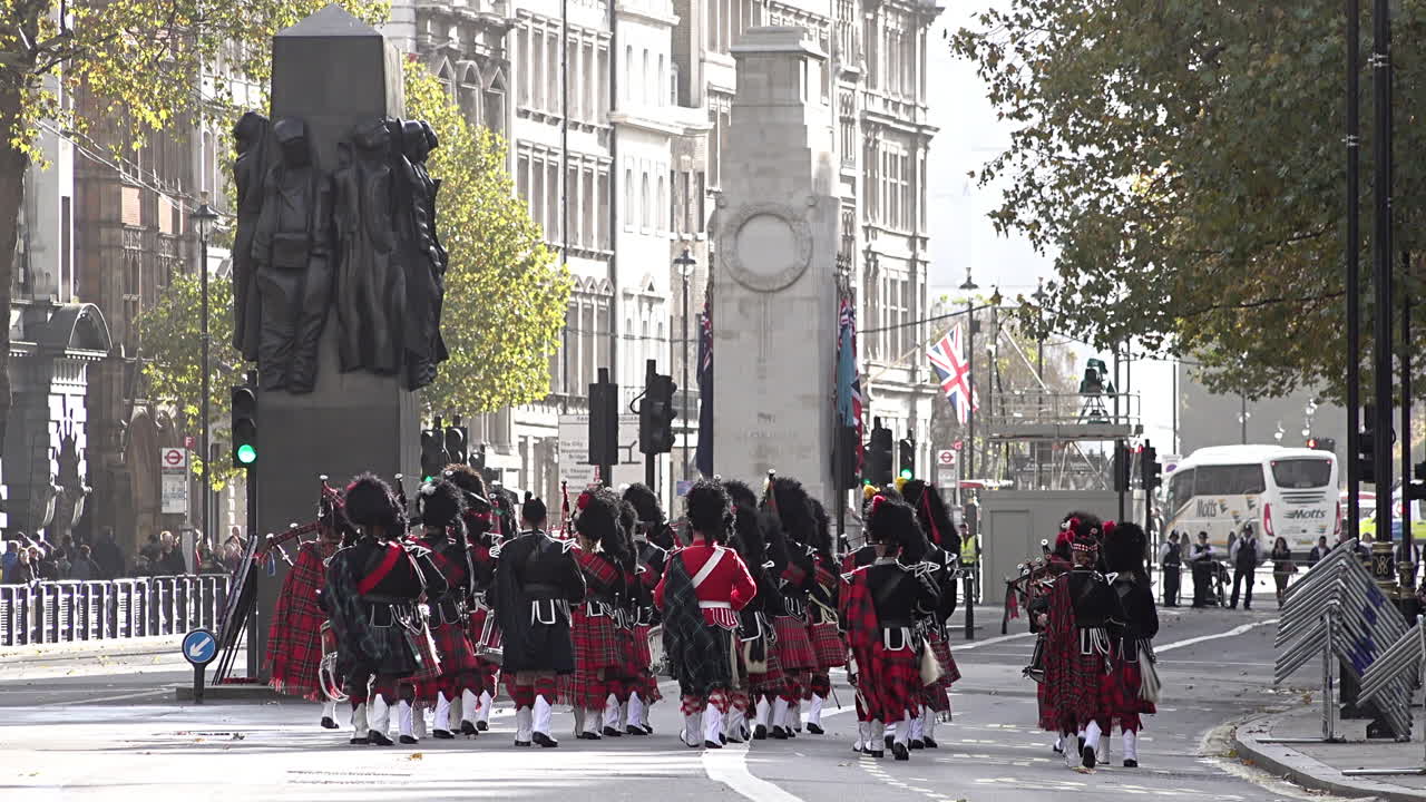 UK November 2018 - The Scottish Highlanders Pipes and Drums march away, past war memorials on Whitehall during Armistice remembrance events on the centenary of the end of World War One.