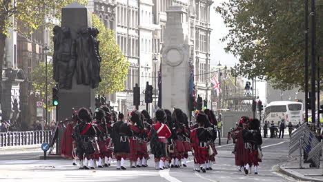 uk november 2018 - the scottish highlanders pipes and drums march away, past war memorials on whitehall during armistice remembrance events on the centenary of the end of world war one.
