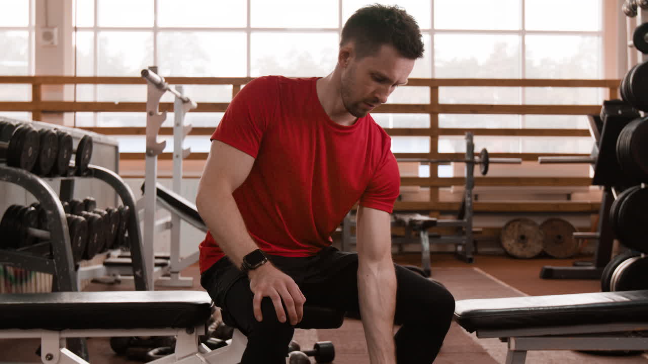 Man exercising with dumbbells in a gym