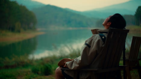 man relaxing by the lake