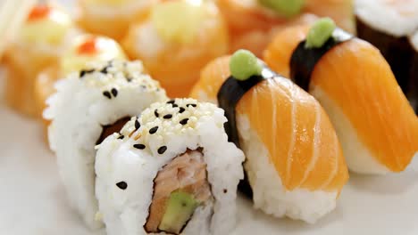 set of assorted sushi served on black stone slate