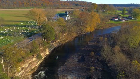 aerial fall flyover of elkhorn creek three kayakers on the creek