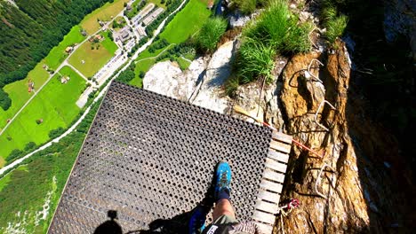 a man walking on a platform for base jumpers and people with wing suits