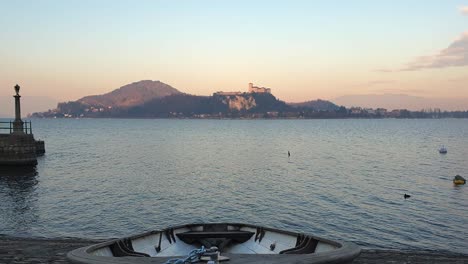 Establishing-zoom-out-shot-of-fishing-boat-pulled-out-of-water-of-Lake-Maggiore,-Italy