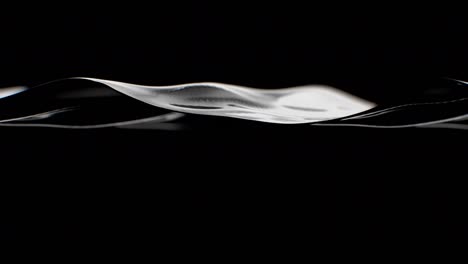 black liquid oil waving in slow motion seamless. abstract water surface moving in black studio shot looped 3d animation. black gold concept.