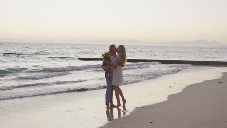 pareja caucásica disfrutando de su tiempo en la playa