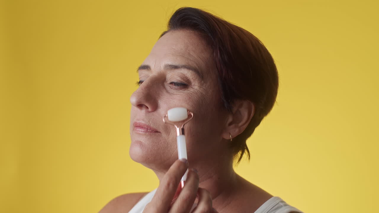 Gen X Woman Doing Anti-age Facial Massage with Gua Sha