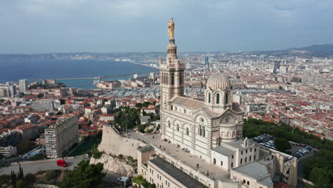 Aerial-reversing-pan-view-of-Notre-Dame-de-la-Garde-in-Marseille-France