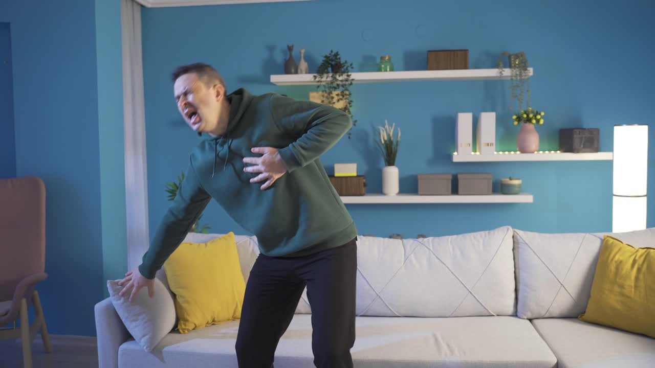 Mature man having heart attack having hard time at home.