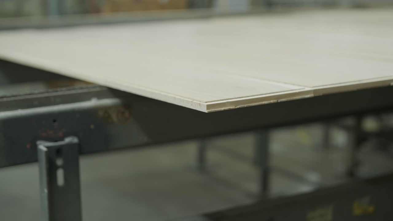 Wooden Panels Moving Along a Conveyor Belt in a Factory