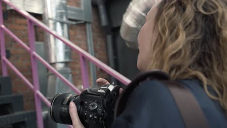 woman photographer taking photos in urban setting