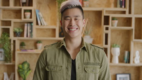 portrait of young happy asian man smiling enjoying successful lifestyle cheerful student wearing stylish fashion confident individuality slow motion