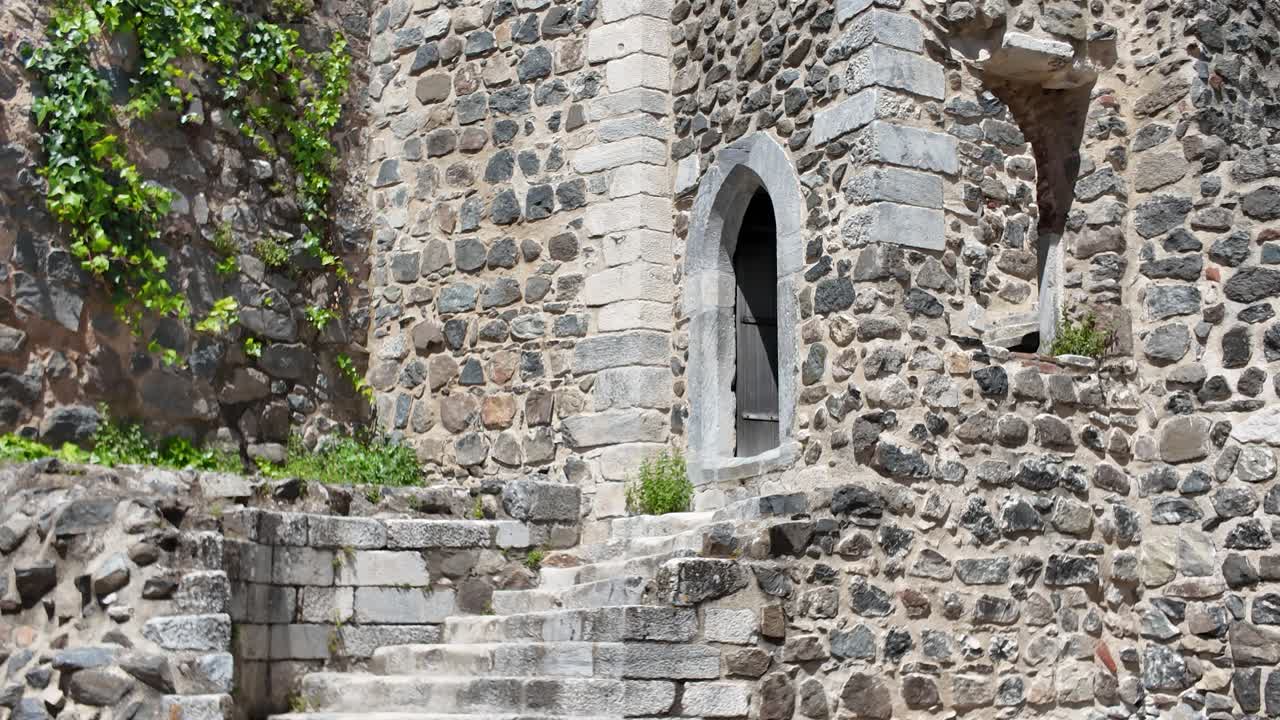 Weathered stone walls and doorway of the historic Castle of Beja, a medieval fortress in Beja, Portugal