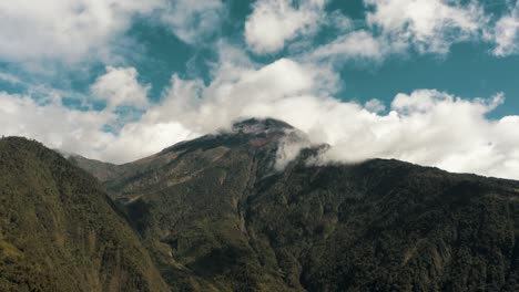 Tungurahua-Volcano-Against-Blue-Cloudy-Sky-In-Baños-De-Agua-Santa,-Ecuador---Tilt-Up