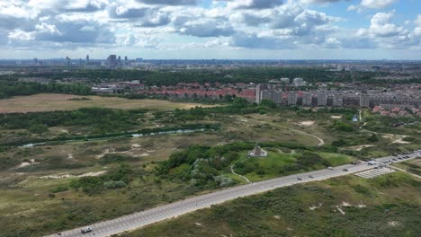 suburbs of den haag city skyline in background, aerial orbit view