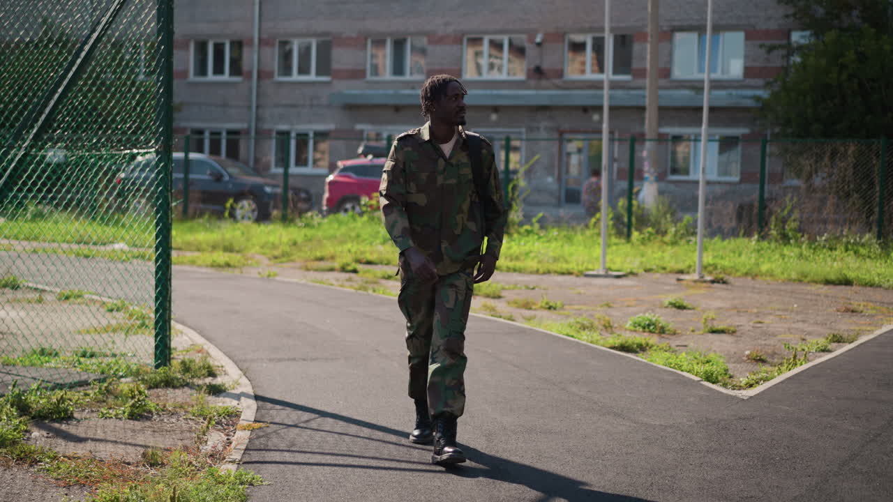 Silent Soldier Advances, Covert Military Personnel Patrols Quiet Neighborhood Streets Unseen, Stealthy Armed Individual Navigates Peaceful Residential Areas Without Attracting Attention