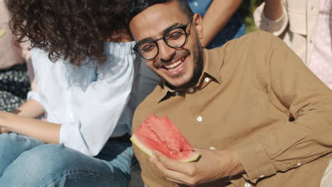 friends enjoying a watermelon picnic