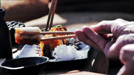 eating sushi with chopsticks in 
asia