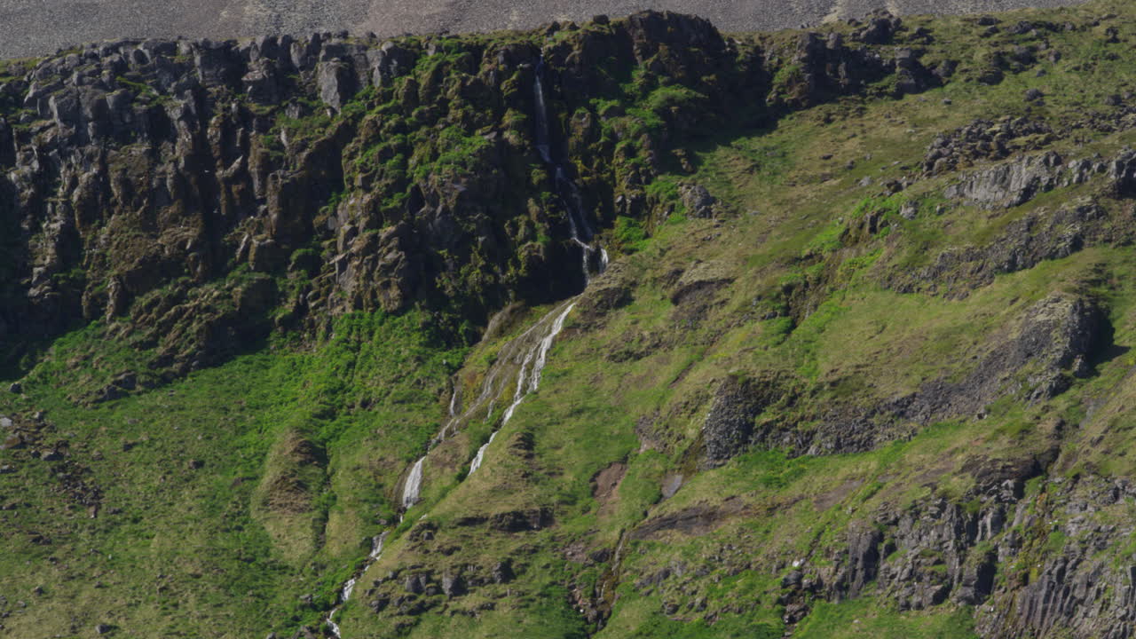 Waterfall in the mountains, Snaefellsnes Peninsula, Iceland, wide shot zoom in