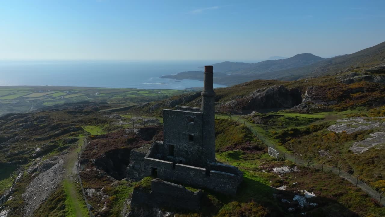 Aerial View of Abandoned Stone Building Ruins on a Mountainside overlooking the Coast