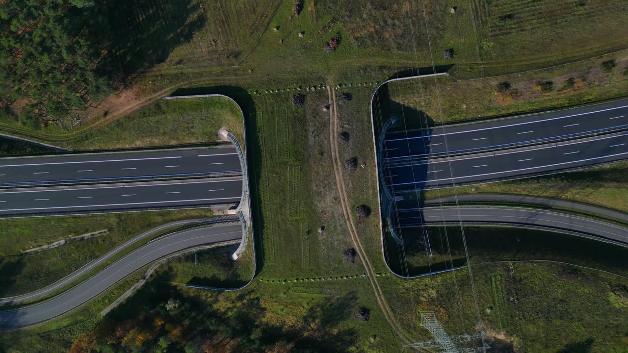 Aerial view showing wildlife crossing over highway in Germany ensuring environmental protection. speed ramp hyper motion time lapse Nice aerial view flight rotation to right drone camera pointing down