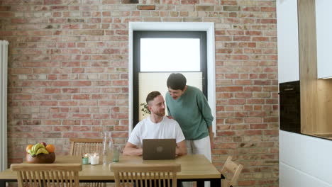 man working on laptop on dining room