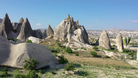 epic cinematic aerial drone shot moving toward a large rock standing over cappadocia, turkey