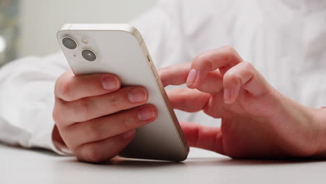 person using a gold color iphone