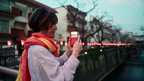 woman taking a photo in a japanese city
