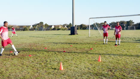 playing soccer, team practicing drills on field with cones and goalposts