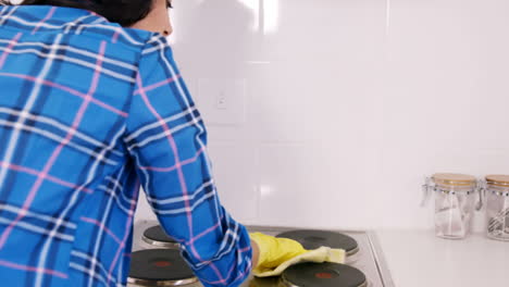 woman cleaning the cooker