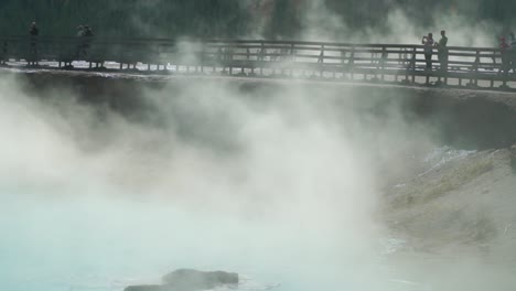 steaming hot clouds obscure the boardwalks at the grand prismatic hot springs in yellowstone national park