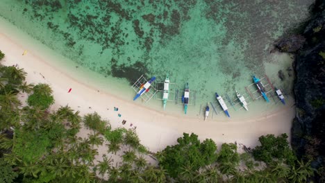 4K-drone-video-of-people-enjoying-Papaya-Beach,-a-tropical-white-sand-beach-in-Palawan,-Philippines