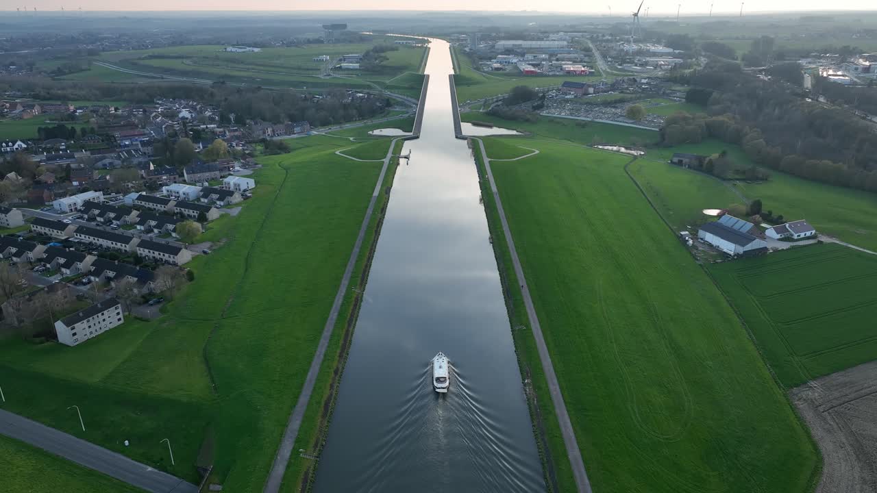 Aerial zoom in revealing a boat moving through the elevated canal in Strépy-Thieu, Le Roeulx during golden hour