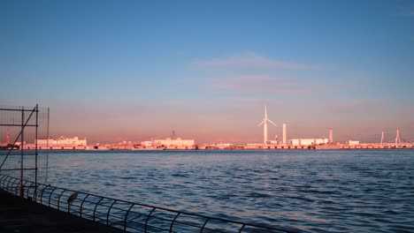 windmill by the sea during sunset in yokohama, japan.