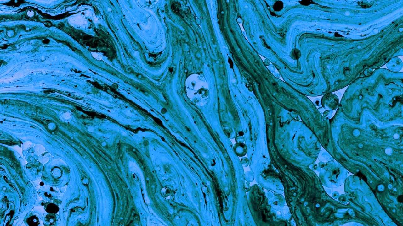 Colorful oil drops floating on water surface, top view. Fantastic abstract background. Bright bubbles moving and spreading. Close up 4k video of weird liquid structures. Scientific chemical experiment