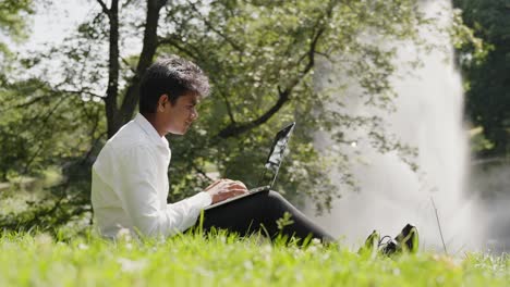 srilankan working remotely from a nature sprinkler park