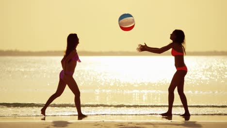 multi ethnic girlfriends on ocean beach at sunset