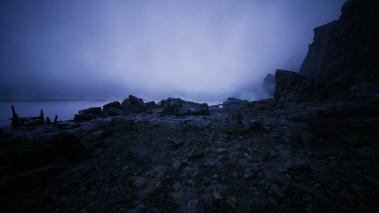 Peaceful rocky coast bathed in gentle blue light early morning