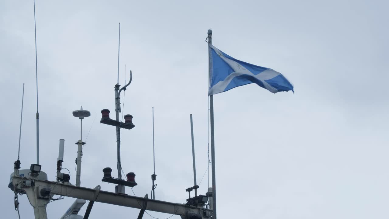 Scottish Flag blowing on the wind on a boats mast.