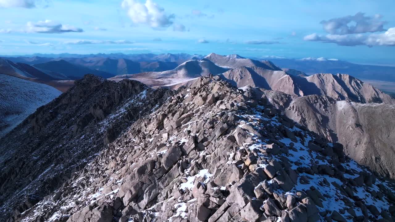 Top of snow covered Mt Mount Shavano Taeguache Peak aerial drone Colorado Collegiate peaks golden hour Rocky Mountains Huron Peak Mt Elbert Sawatch Range above treeline fall autumn forward motion
